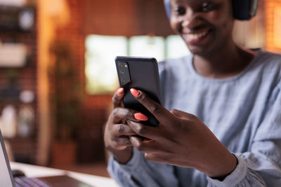 Midsection of man using mobile phone