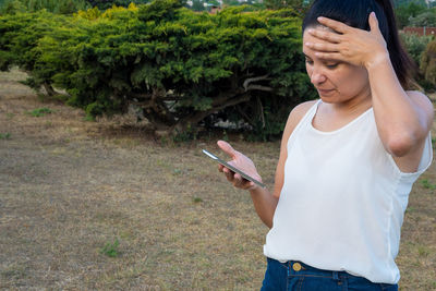 Portrait of young woman using mobile phone