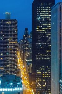 Illuminated cityscape against sky seen through window