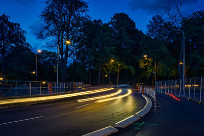 View of light trails on street at night