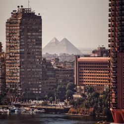 Buildings in city against clear sky