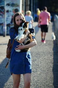 Young woman with dog walking outdoors
