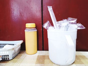 Close-up of drink on table against wall