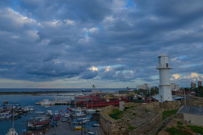 High angle view of buildings by sea against sky