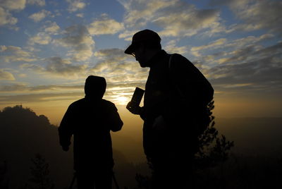 Silhouette of people at sunset