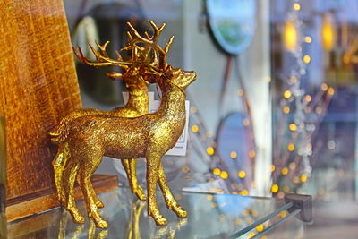 Gold reindeer figurines on shelf at home