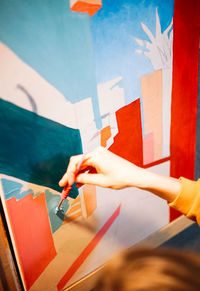 Midsection of woman holding paper