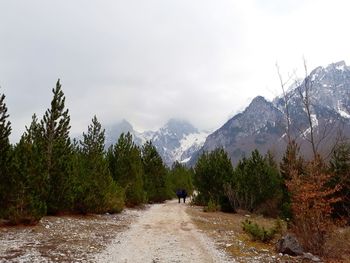 Rear view of people on mountain against sky