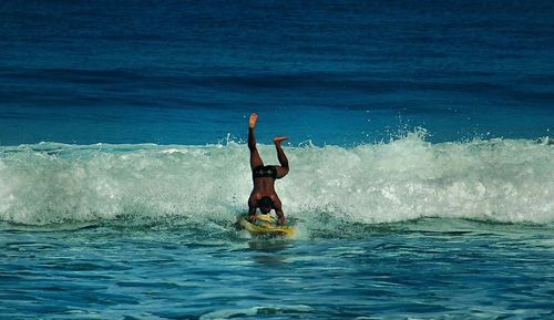 People surfing in sea