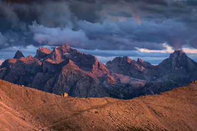 Scenic view of mountains against cloud sky during sunset