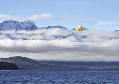 Scenic view of lake and mountains against sky