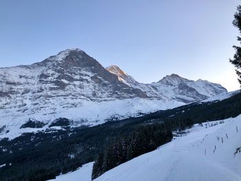 Scenic view of snowcapped mountains against clear sky