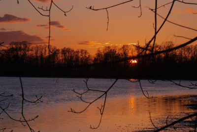 Scenic view of lake against orange sky