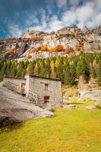 Stone wall of building with mountain in background