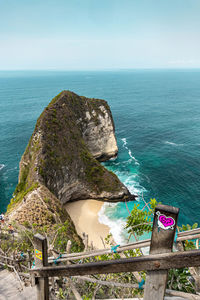 High angle view of rocks by sea against sky