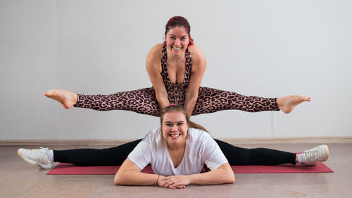 Happy woman exercising together at home