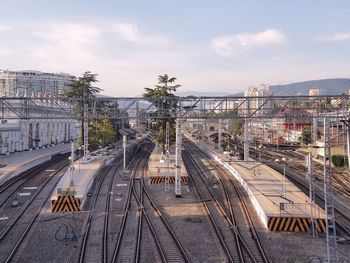 High angle view of railroad tracks by buildings in city against sky