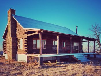 Abandoned building against clear blue sky