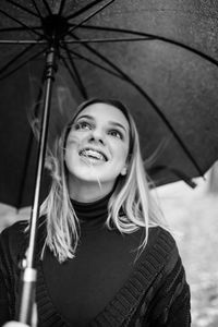 Portrait of a smiling young woman in rain