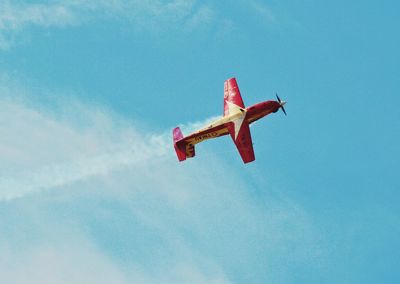 Low angle view of airplane flying against sky