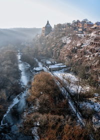 High angle view of river amidst buildings during winter