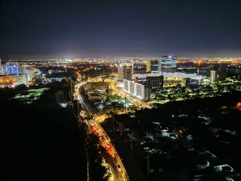 High angle view of illuminated buildings in city at night