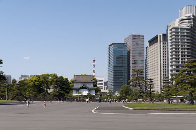 Empty road with buildings in background