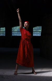 Portrait of woman standing against wall