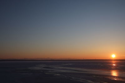 Scenic view of sea against clear sky during sunset