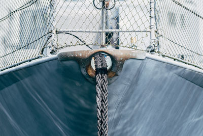 Shadow of person on rope in boat at sea