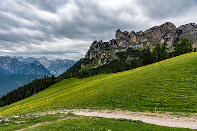 Scenic view of green mountains against sky