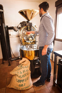 Side view of man working at cafe