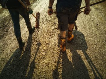 People walking on wet muddy floor after a flood