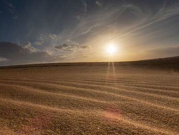 Scenic view of field against sky during sunset