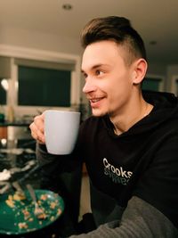 Smiling man holding coffee cup