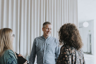 Smiling business people talking together