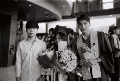 Portrait of young couple standing in corridor