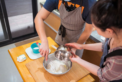 Midsection of woman holding food on table