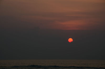 Scenic view of sea against orange sky