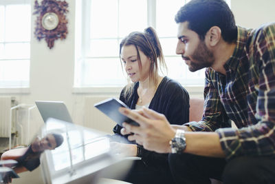 Business people working on laptop in creative office