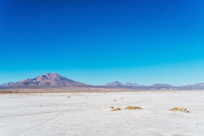 View of desert against blue sky