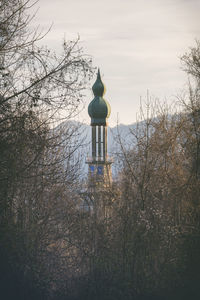 Low angle view of cross on building against sky