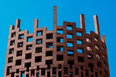 Low angle view of building against clear blue sky