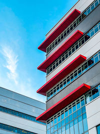 Low angle view of modern building against blue sky