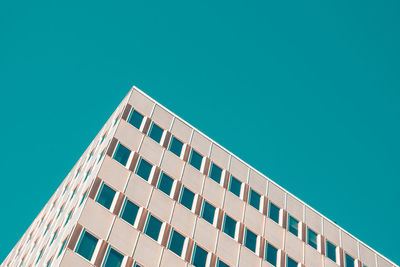 Low angle view of modern building against clear blue sky