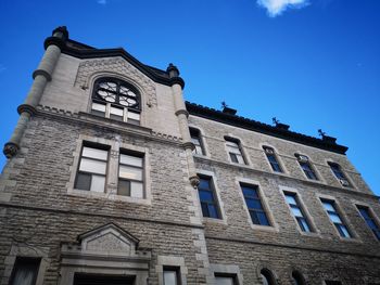 Low angle view of old building against clear blue sky