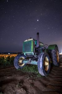 Vintage car on field against sky at night