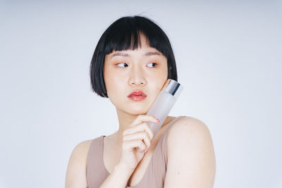 Portrait of a beautiful young woman over white background