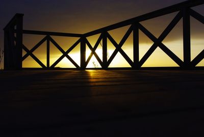 Silhouette bridge against sky at sunset