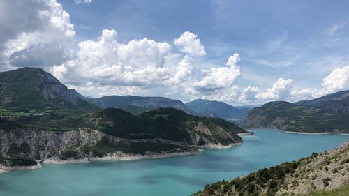 Panoramic view of sea and mountains against sky